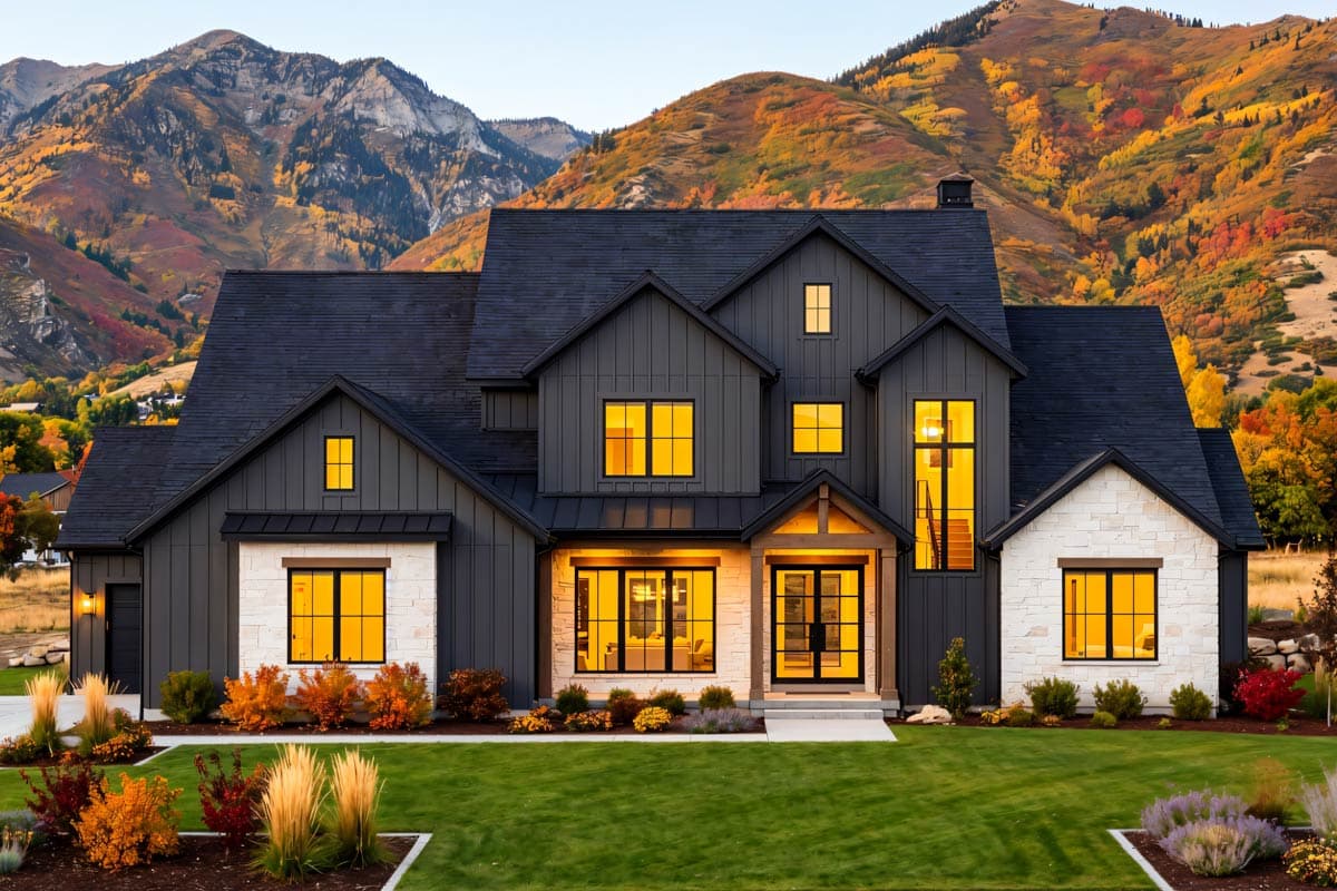 Modern Farmhouse house plan exterior with dark siding, stone accents, multiple gables, and prominent dormers.