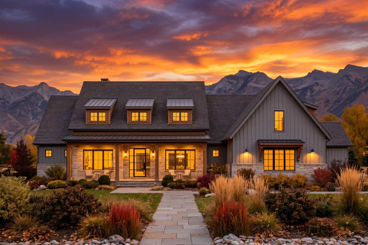 House plan exterior: Two-story modern farmhouse with stone and board-and-batten siding, covered porch, and multiple gables.