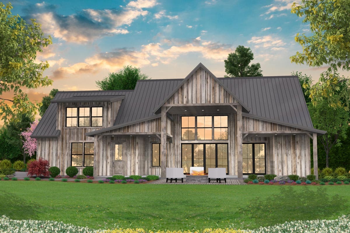 Modern farmhouse house plan exterior with metal roof, prominent gables, and large multi-pane windows.