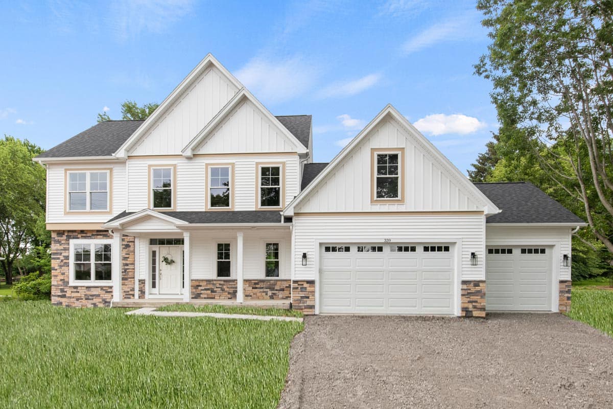 House plan exterior: Two-story Modern Farmhouse with gables, a covered front porch, stone accents, and a three-car side-entry garage.