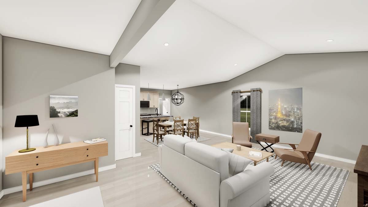 Open concept living, dining, and kitchen area with vaulted ceiling, island, and fireplace.