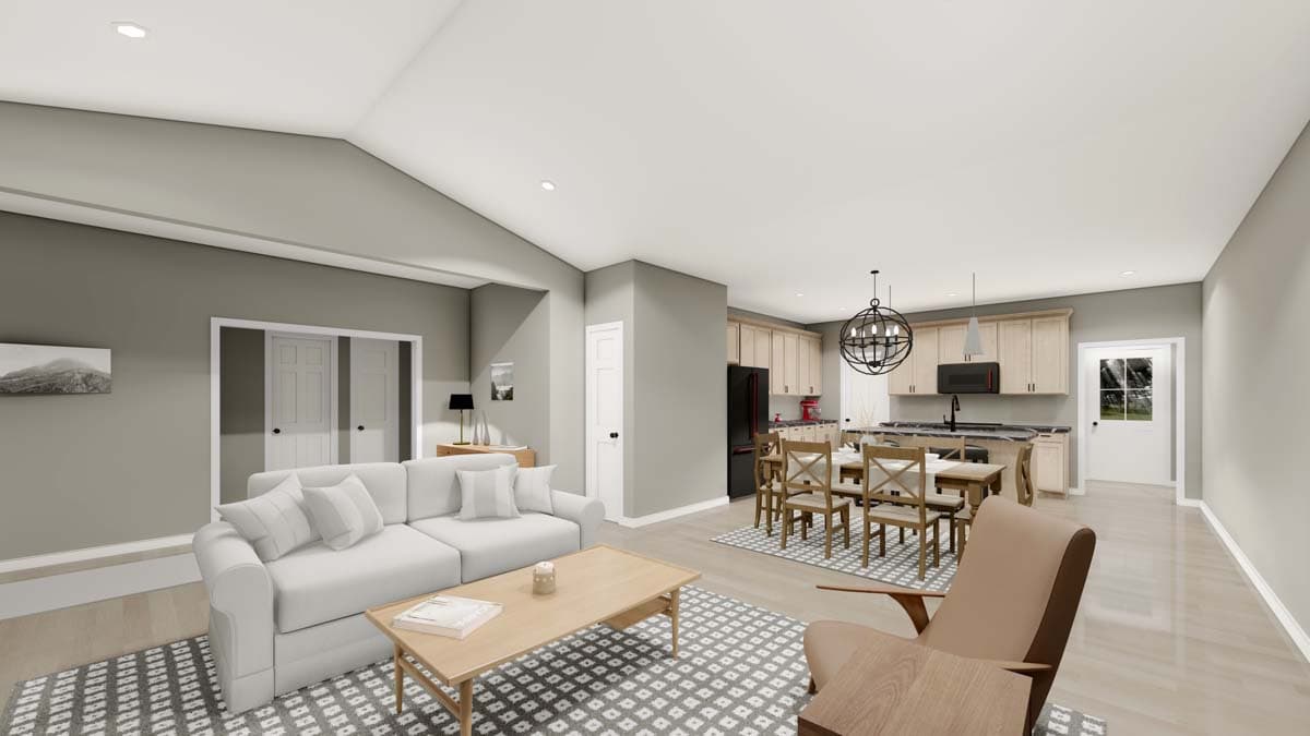 Open concept living area with vaulted ceiling, sofa, dining table, and kitchen with island.