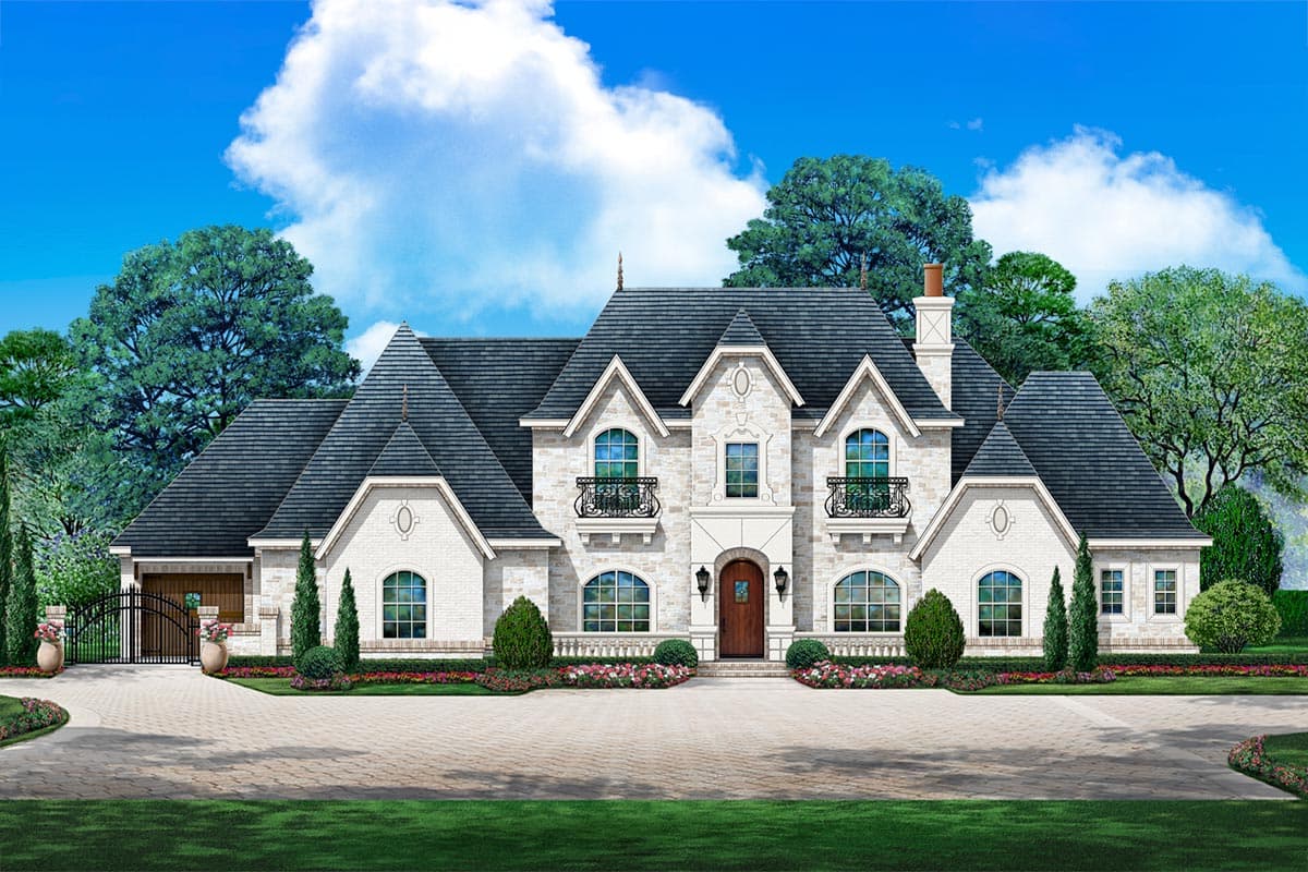 House plan exterior. Two-story French style home with multiple gables, arched windows, and a detached garage with a wrought iron gate.