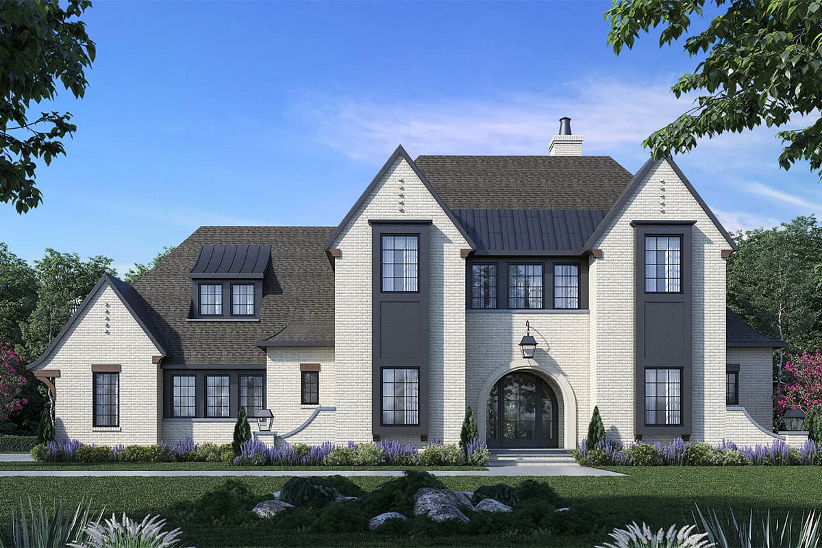 House plan exterior. Two-story Tudor style home with arched entryway, multiple gables, and metal roof accents. Brick facade and dormers.
