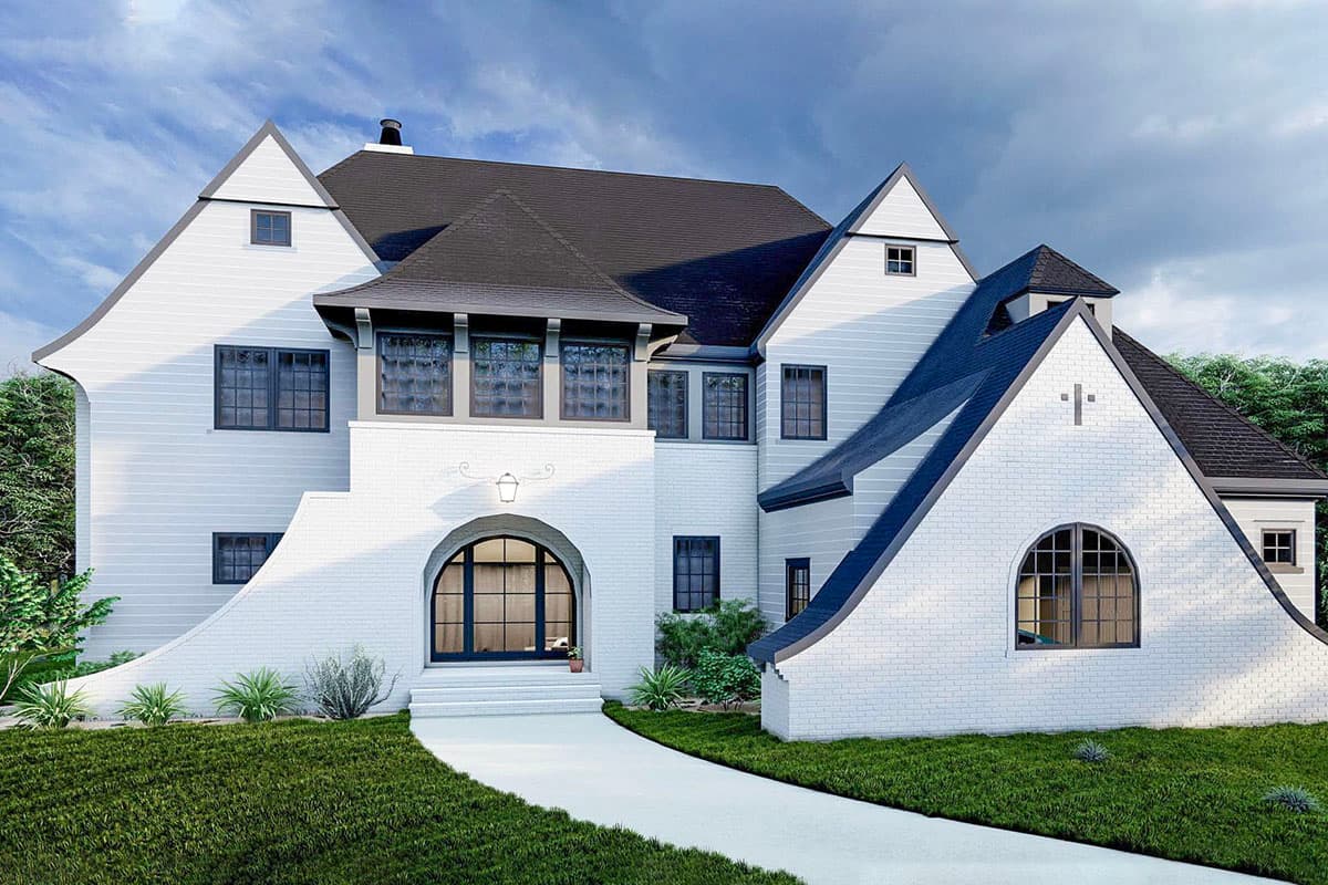 House plan exterior. Two-story home with a steep gable roof, arched entryway, and dormers. Features a curved wall and a Palladian window.