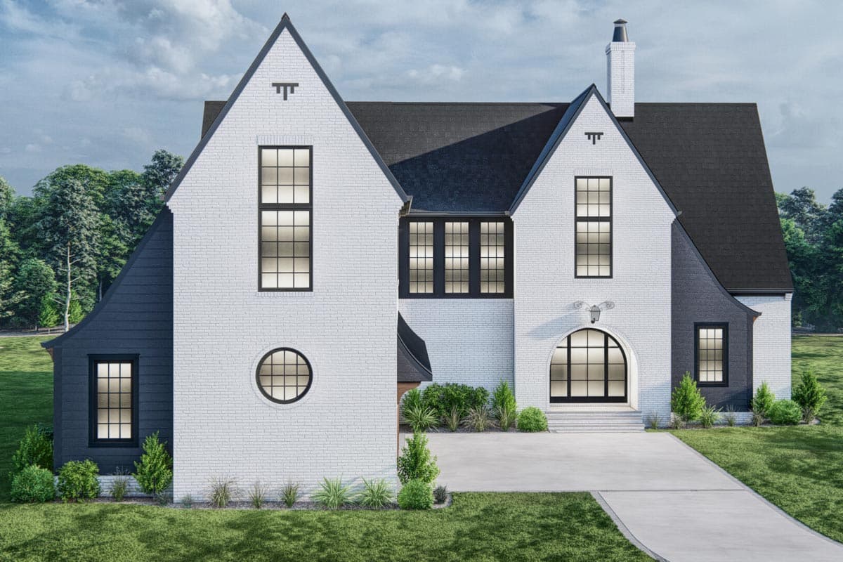 House plan exterior: Two-story Tudor-style home with white brick, dark gable siding, pointed gables, arched entry, and black-paned windows.