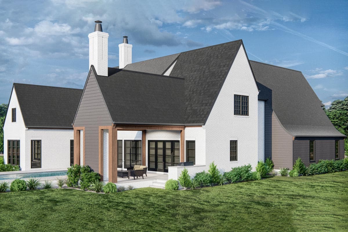 House plan exterior: Modern style, white brick, gabled roofs, two prominent chimneys, covered patio with outdoor seating, and a pool.