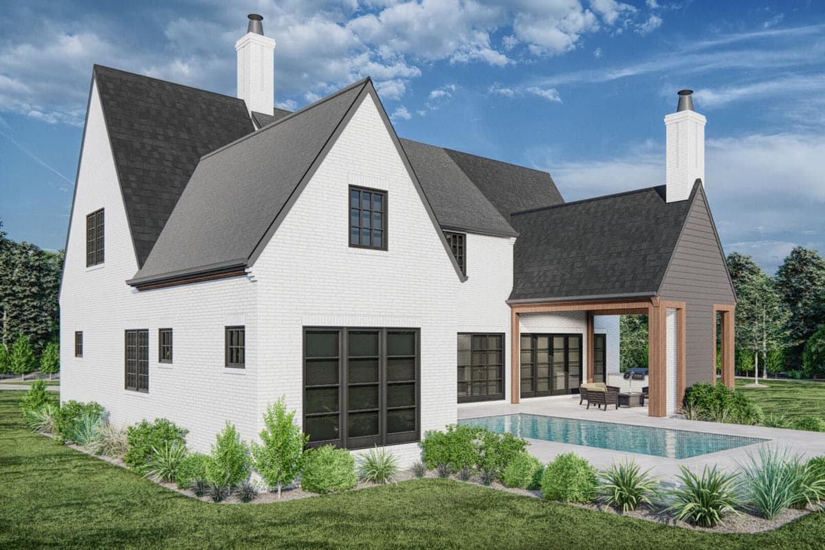 House plan exterior, two stories, white brick facade, gabled rooflines, prominent chimney, and covered outdoor living space.