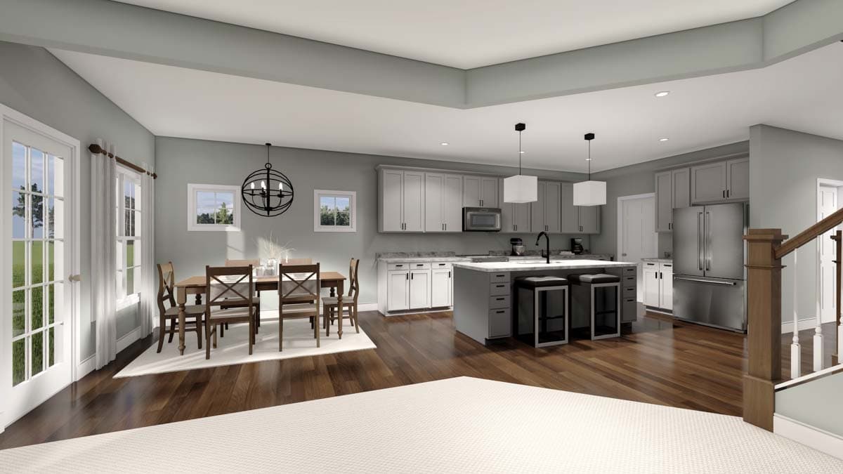 Open-concept kitchen and dining area with a large island, light gray cabinets, stainless steel appliances, and a dining table with four chairs.