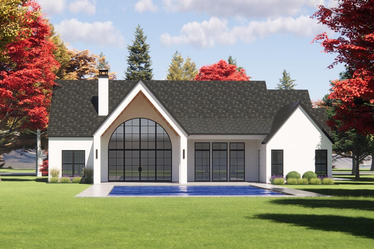 Modern house plan exterior with a large arched window, gabled roofs, chimney, and swimming pool.