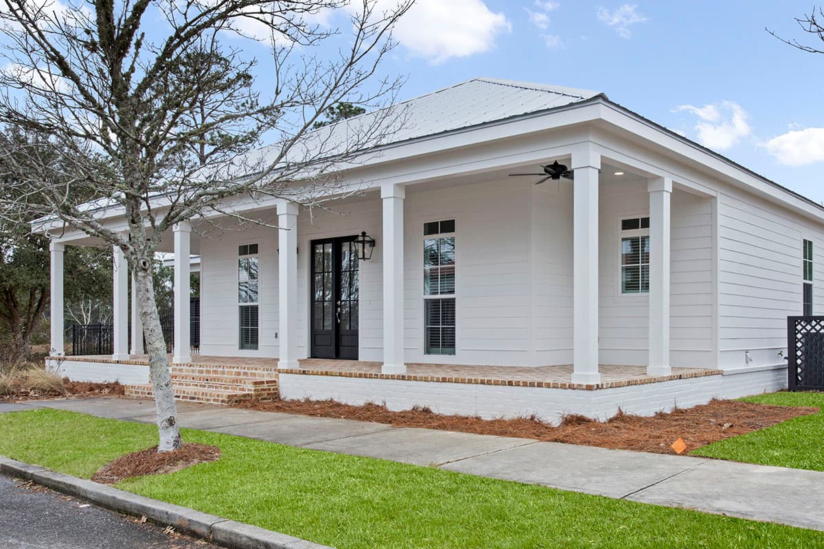 House plan exterior: one-story Modern Farmhouse with wraparound porch, metal roof, and double front doors.