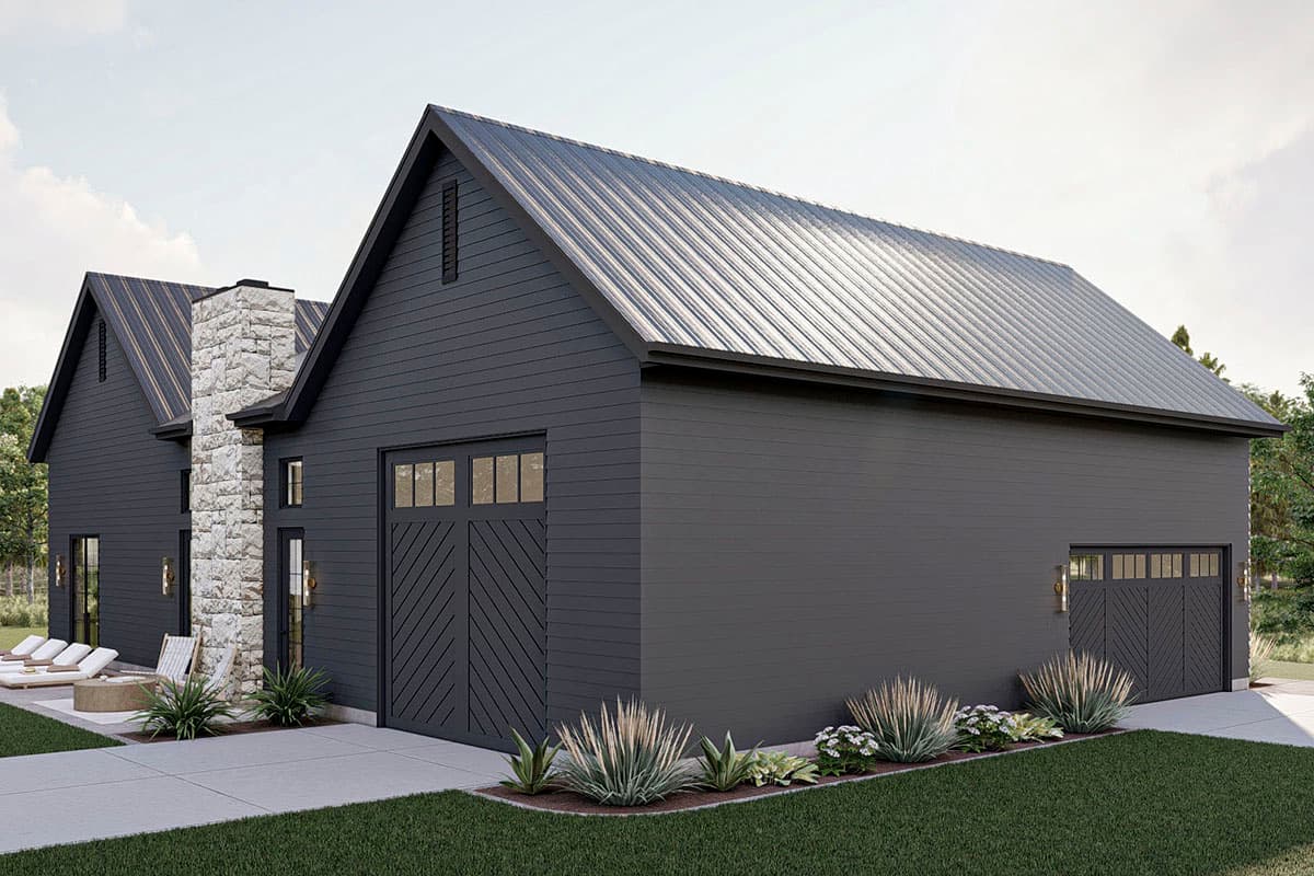 Modern farmhouse house plan exterior with a metal roof, stone chimney, and two garage doors.