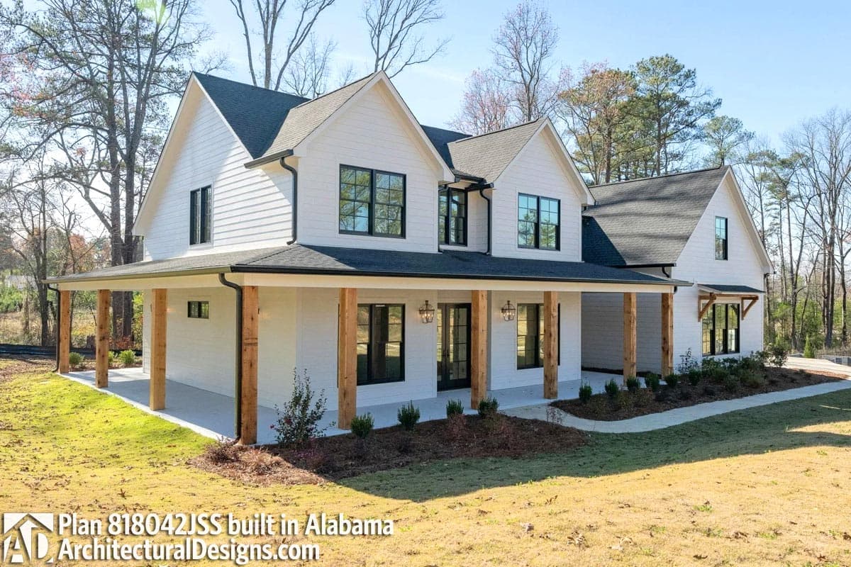 Modern Farmhouse house plan exterior, two stories, with wrap-around porch supported by timber posts and multiple gables.