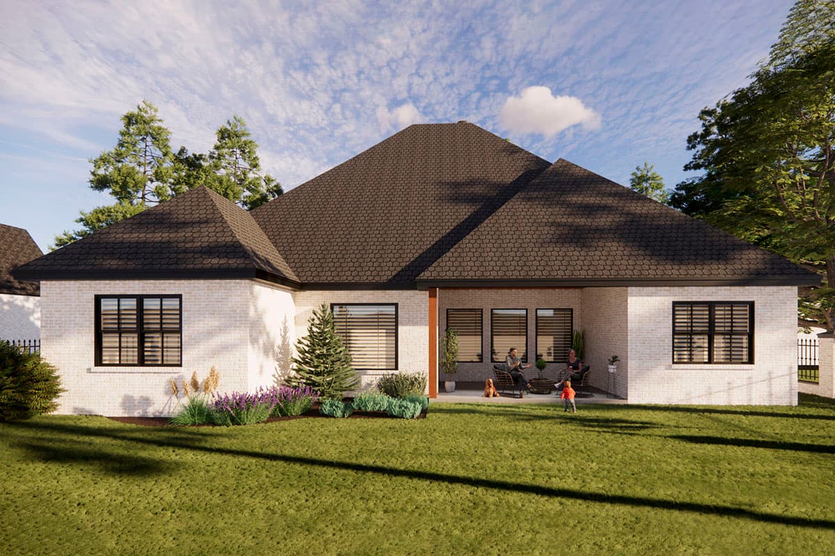 House plan exterior with white brick, dark multi-level rooflines, and a covered patio with seating.