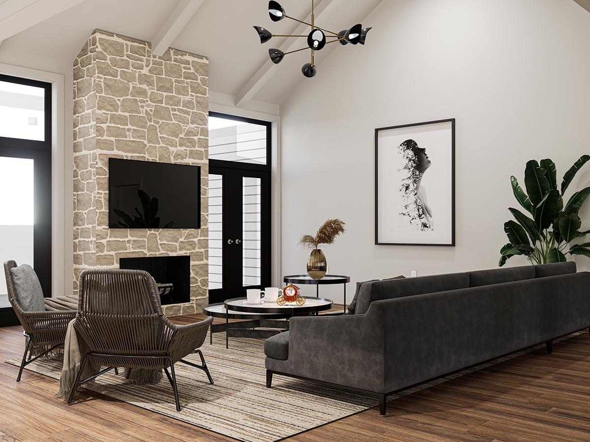 Living room with stone fireplace, vaulted ceiling, large windows, contemporary chandelier, and artwork.