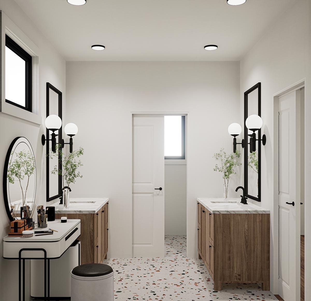 Bathroom with two wood vanities, marble countertops, modern sconces, and a separate vanity area with an oval mirror.