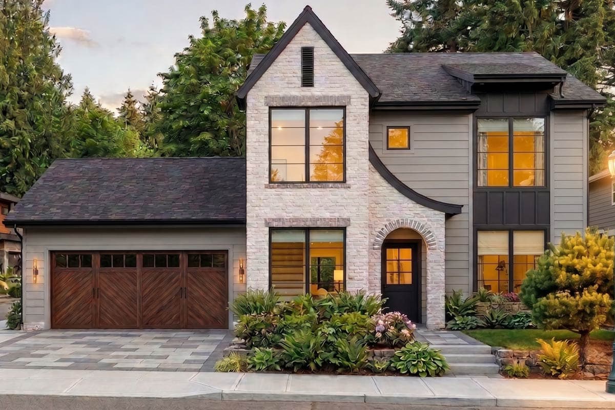 House plan exterior. Two-story, Modern style home with brick accents and a gabled roof. Features include an arched entry and a side-entry garage.