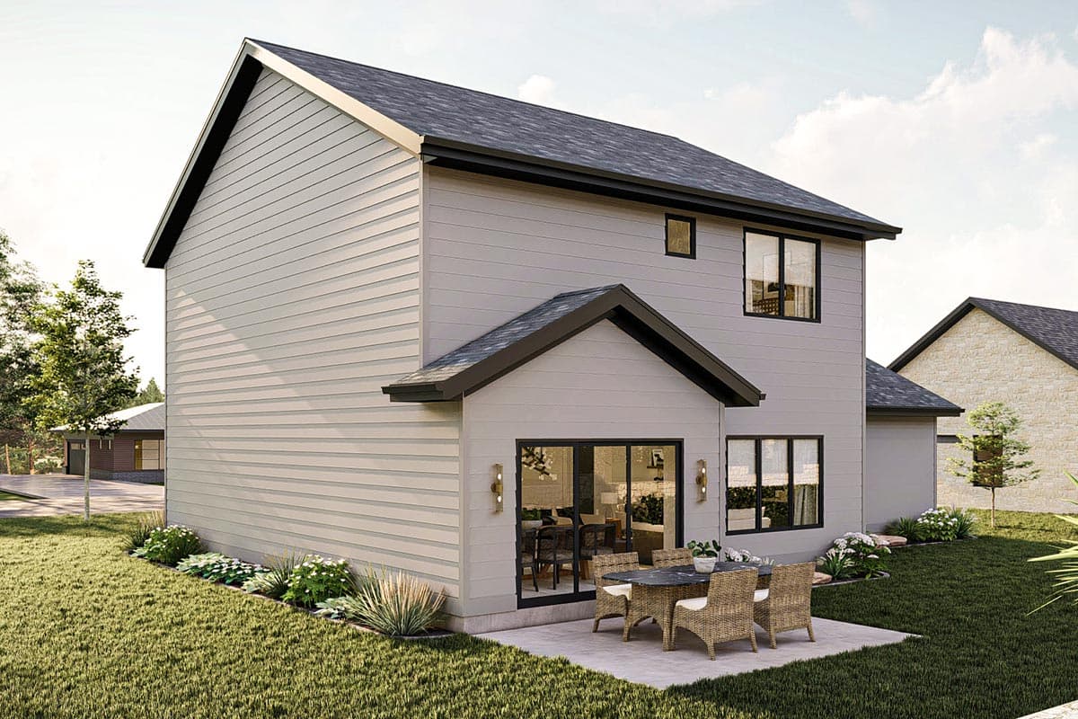 Modern house plan exterior, two stories, with horizontal siding, gabled roof, and patio with outdoor dining set.