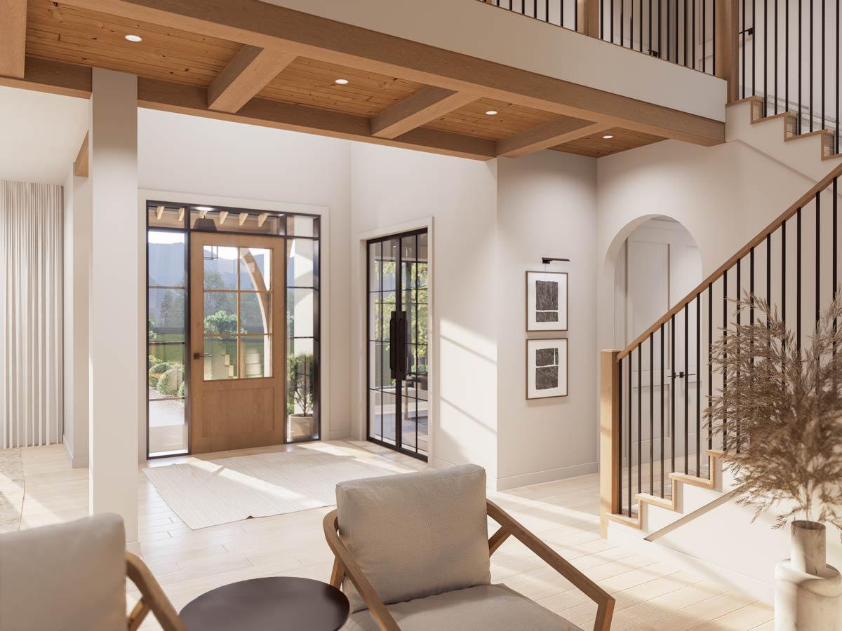 Interior view of a house entry with wood coffered ceiling, wood and glass front door, and a staircase with black railings.