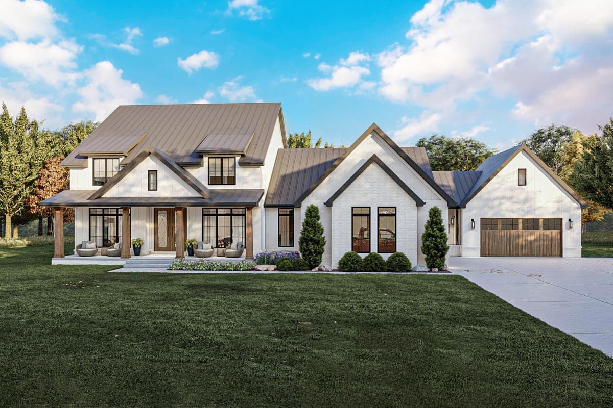 House plan exterior. Modern Farmhouse style, two-story home with a gabled roofline, front porch, and attached garage with a carriage door.