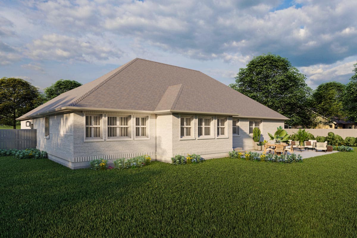 House plan exterior view of a one-story home with white brick, multiple gables, and a patio with outdoor furniture.