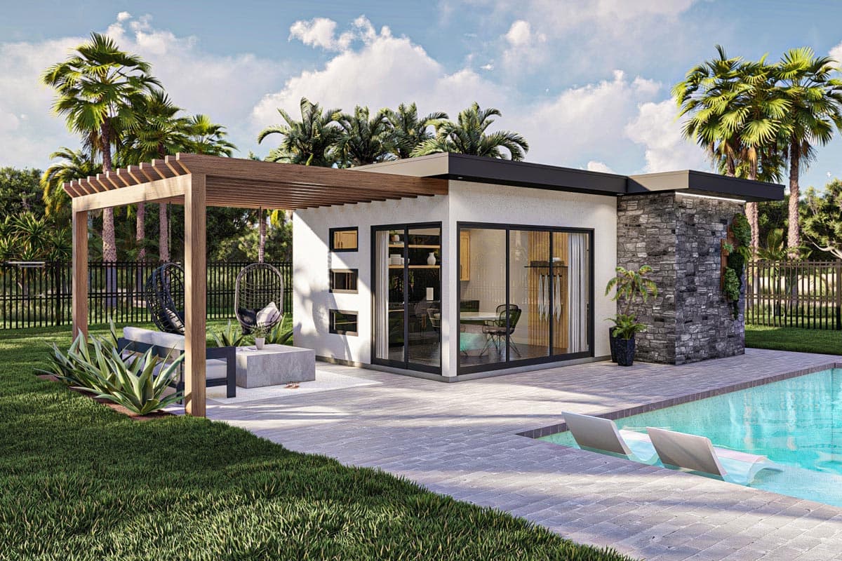 A modern pool house with a pool, patio, and seating area. Palm trees frame the building with sleek black-framed glass walls.