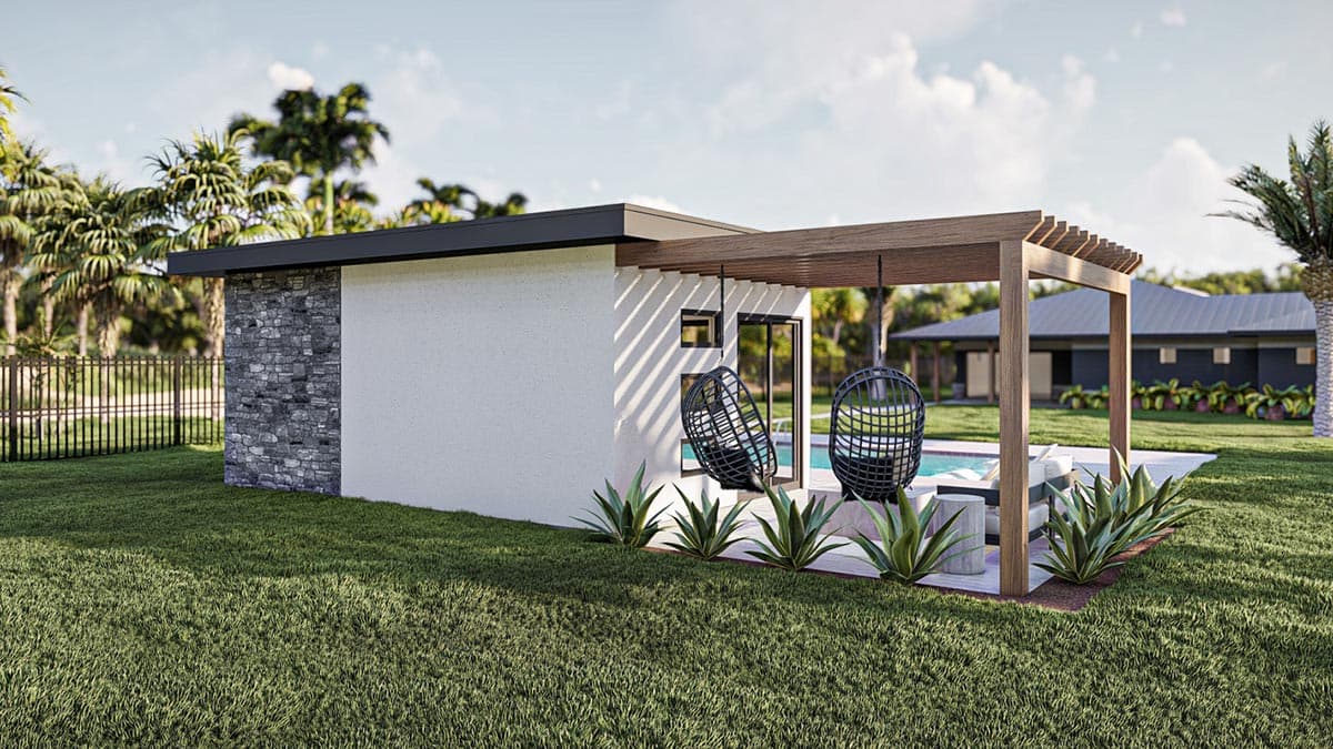 Modern outdoor space with a white stucco building, stone accent wall, hanging chairs, and a pool. Lush green grass and palm trees surround the scene.