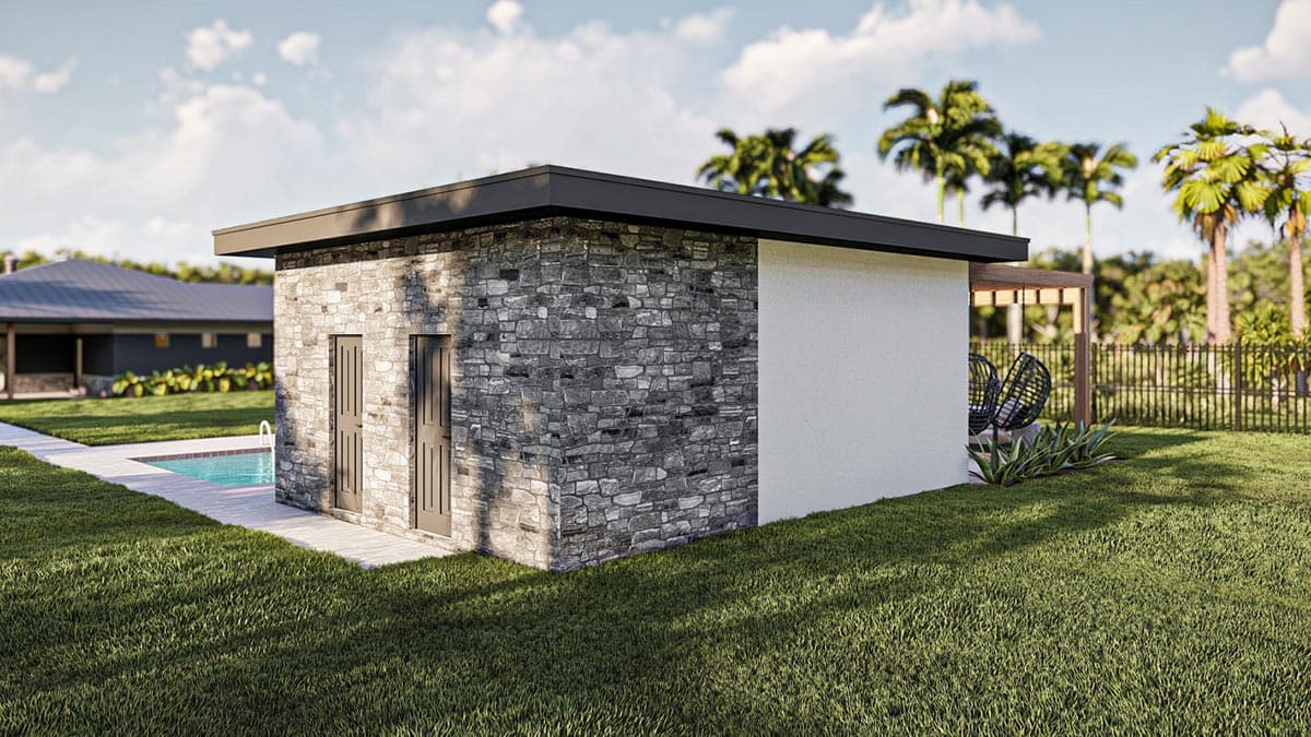 A modern building with a stone facade, beside a pool. Palm trees and a fence are in the background, with chairs on a small patio.