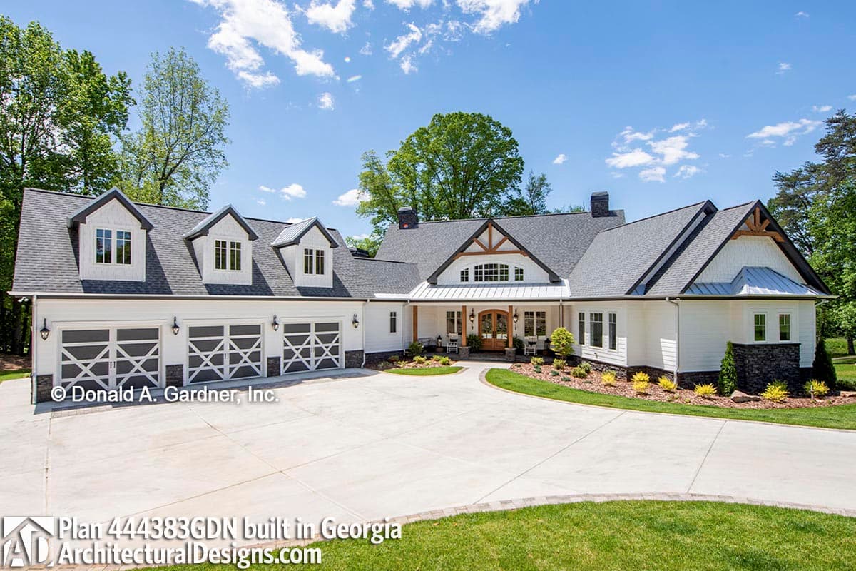 House plan exterior with modern farmhouse style, three-car garage, gables, dormers, and covered entry.