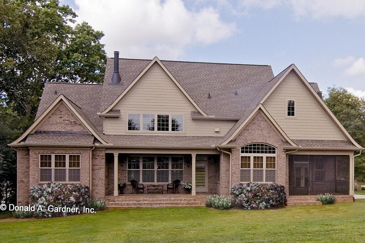 House plan exterior with brick and siding, front covered porch, gables, dormers, and multiple windows.