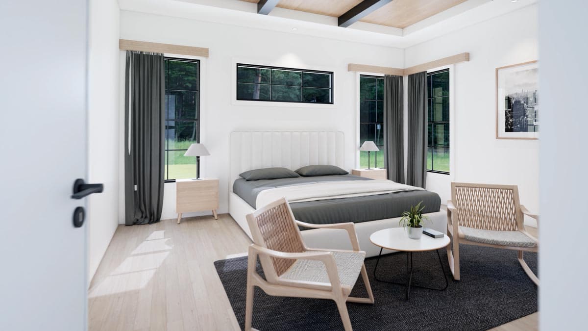 A modern bedroom with a large bed, two bedside tables with lamps, windows with curtains, and a wooden armchair in front.