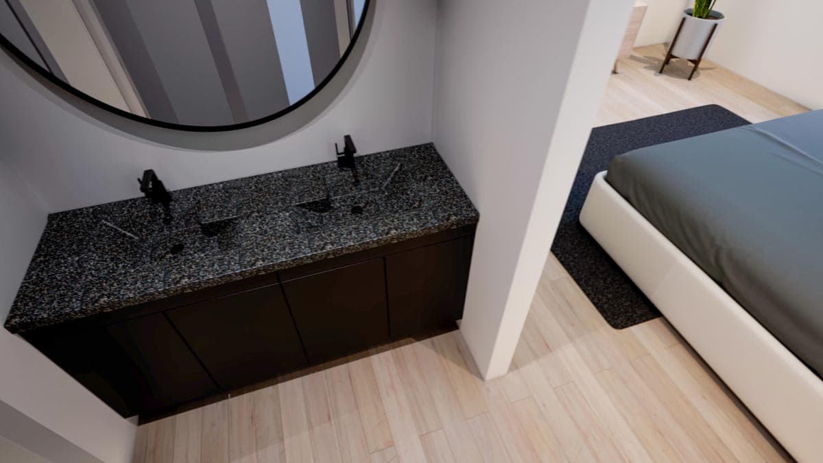 Modern bathroom featuring a dark granite countertop with two sinks and black fixtures, a large round mirror, and a bed in the adjacent room.