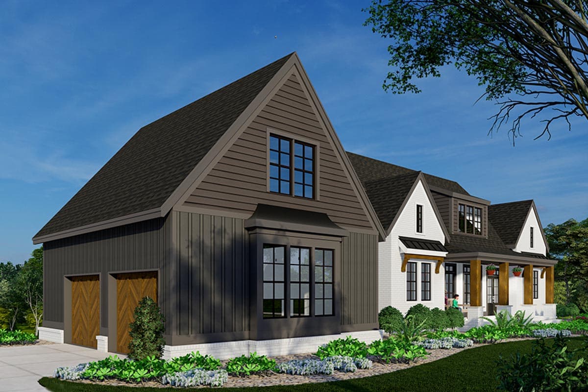 A modern house with a mix of dark and white siding, featuring a garage, multiple gabled roofs, and a welcoming porch under a clear sky.