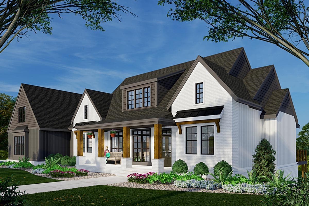 A modern, two-story house with a white brick exterior, dark gray roof, and a welcoming porch. Landscaping features flowers and neatly trimmed bushes.