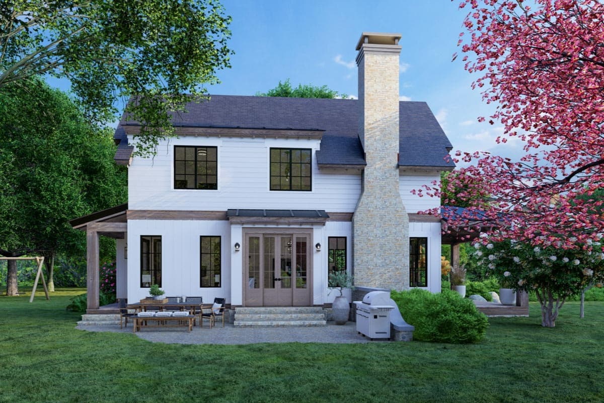 House plan exterior: Two-story Modern Farmhouse with white siding, prominent stone chimney, covered porch, and large windows.