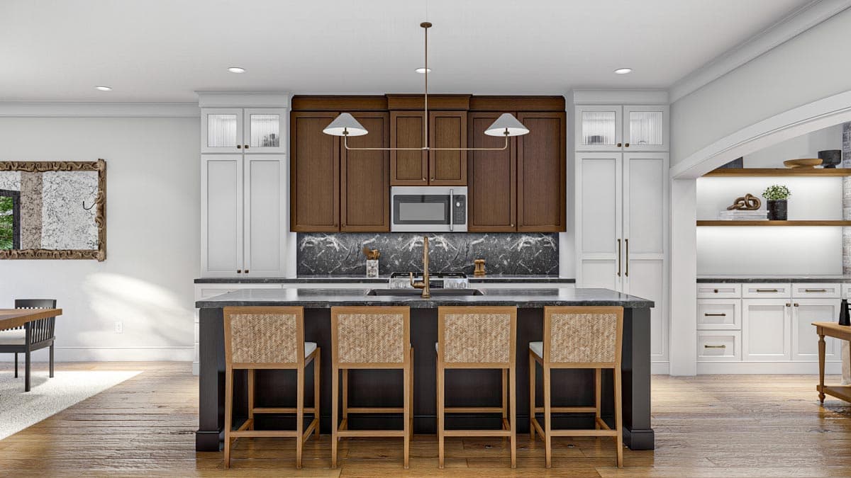 Modern kitchen with dark island, marble backsplash, built-in microwave, and counter stools.