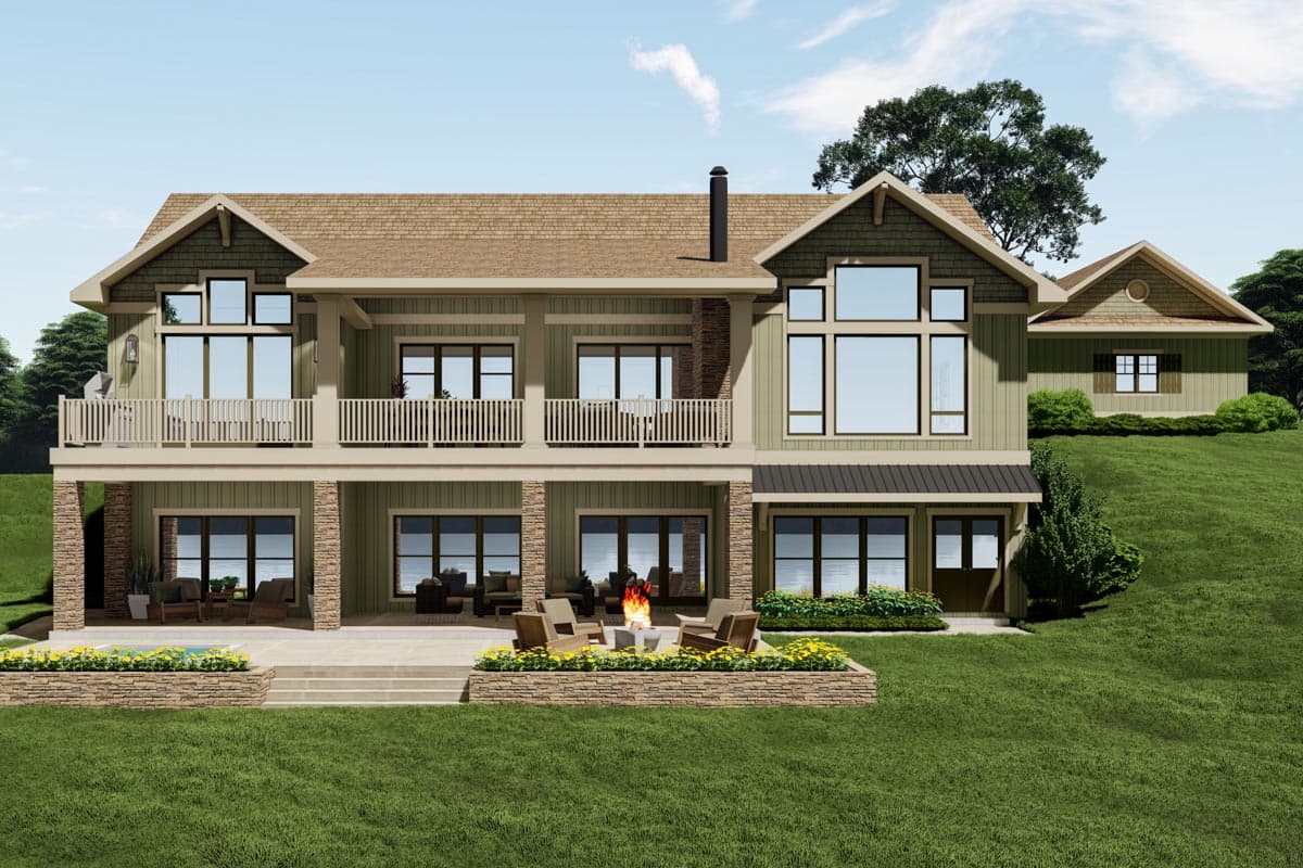 Two-story house plan exterior with layered gables, upper balcony, stone accents, and lower-level patio.