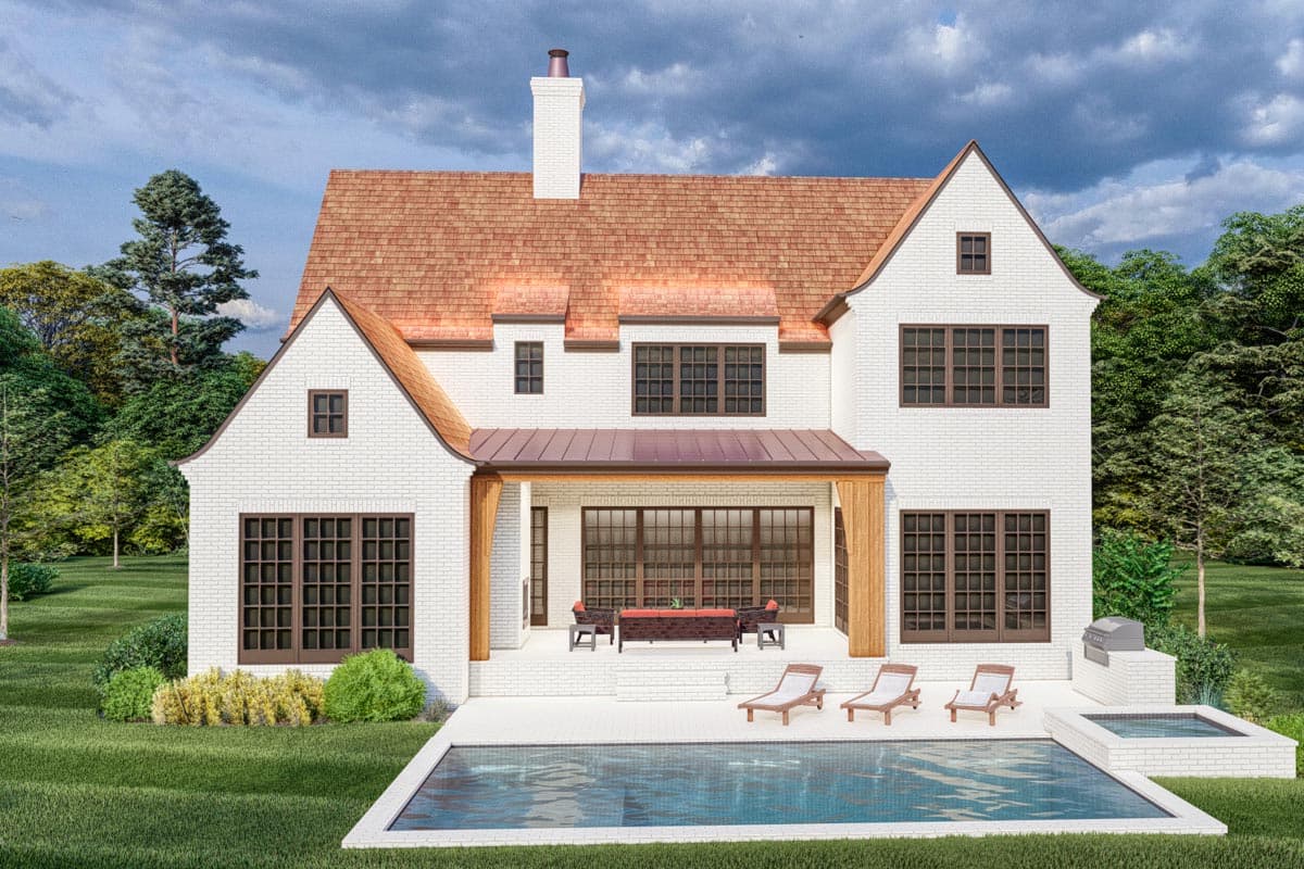House plan exterior: White brick two-story home with a copper roof, gables, dormers, covered patio, and swimming pool.