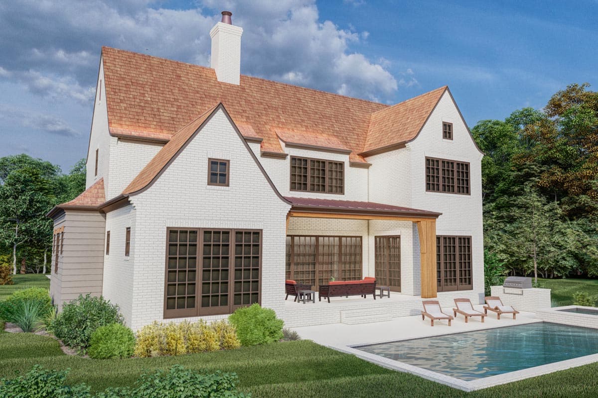 House plan exterior: Two-story white brick home with gabled rooflines, dormers, white chimney, and covered rear porch.