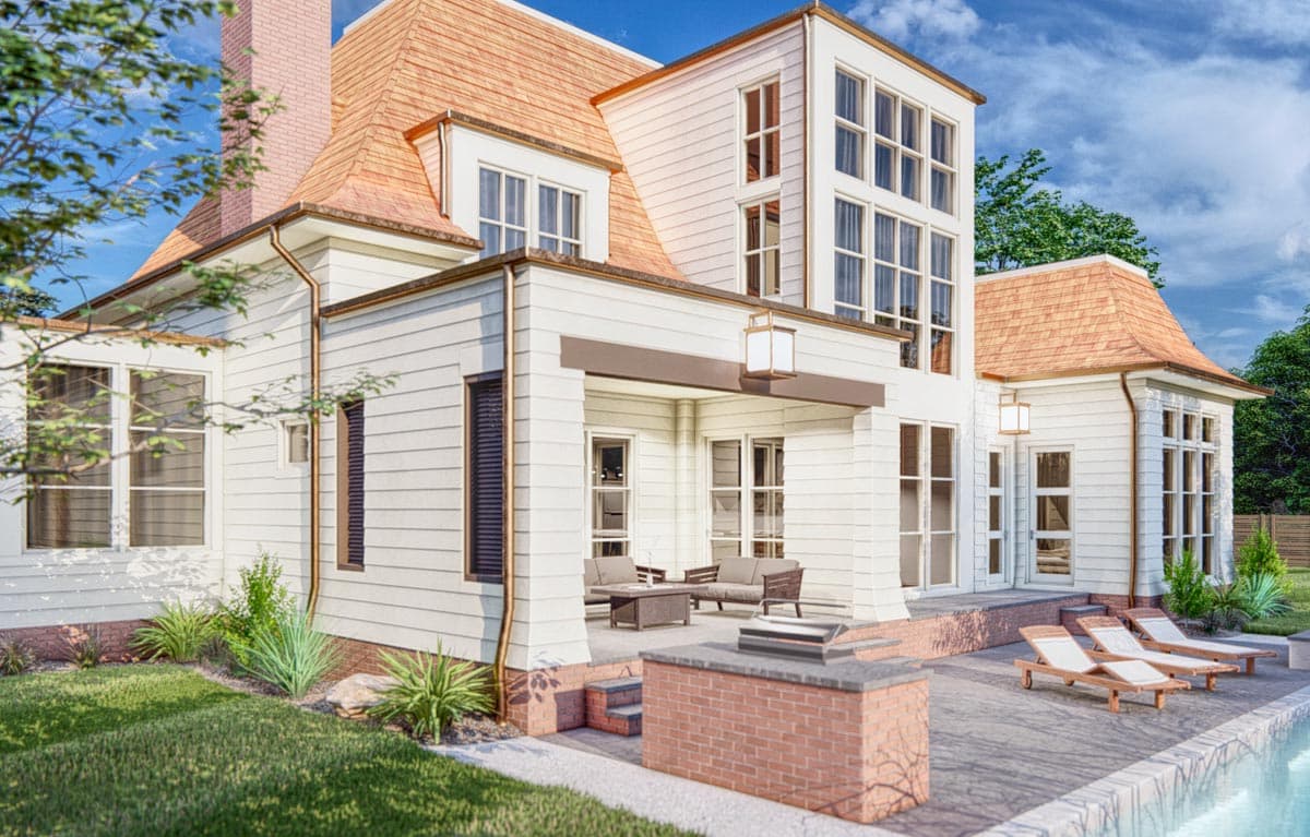 House plan exterior: White siding, gable roof with copper gutters, covered porch with seating, and outdoor kitchen.