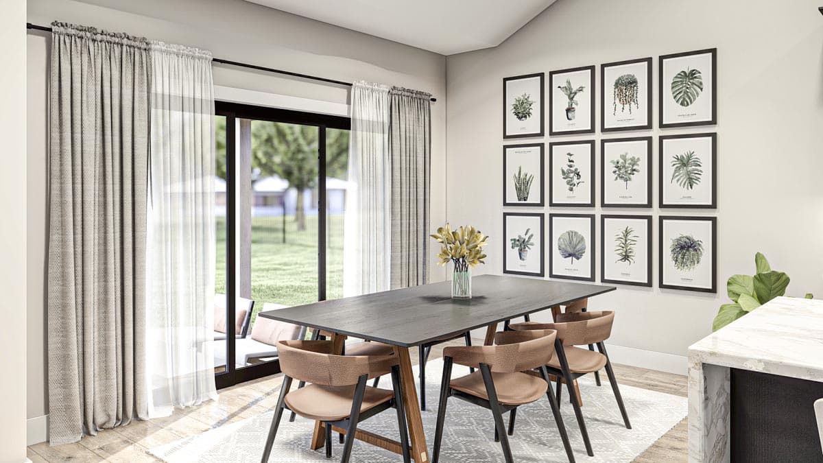 Dining room with a large dark wood table, six chairs, wall art of botanical prints, and sliding glass doors.