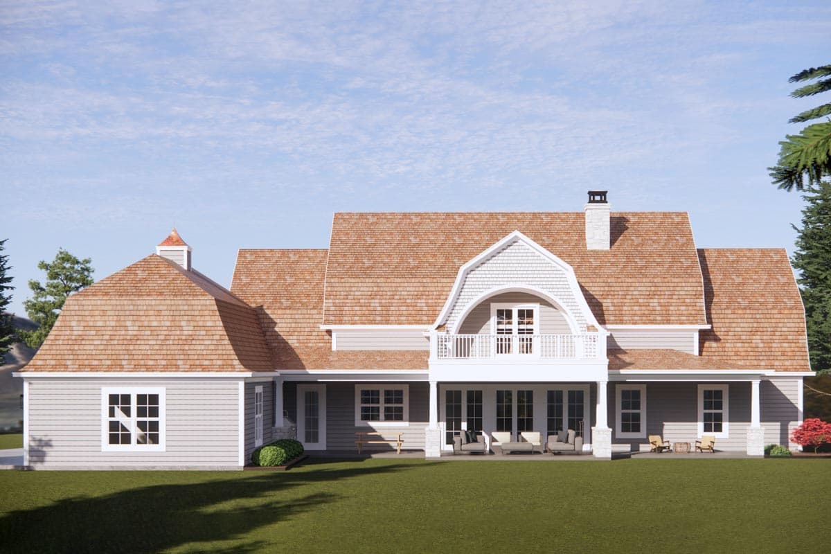 House plan exterior shows a two-story home with gambrel rooflines, dormers, a balcony, and a cupola.