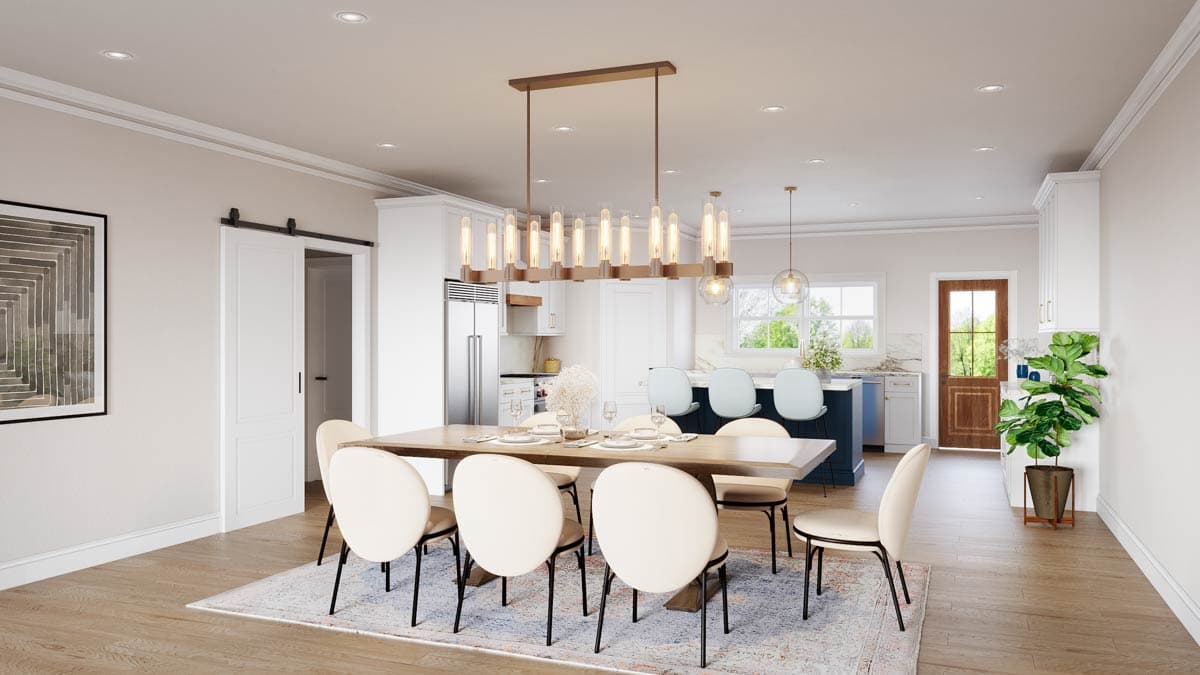Spacious dining room with a long wooden table, eight chairs, and a modern chandelier. Kitchen with an island and doors leading outside are visible.