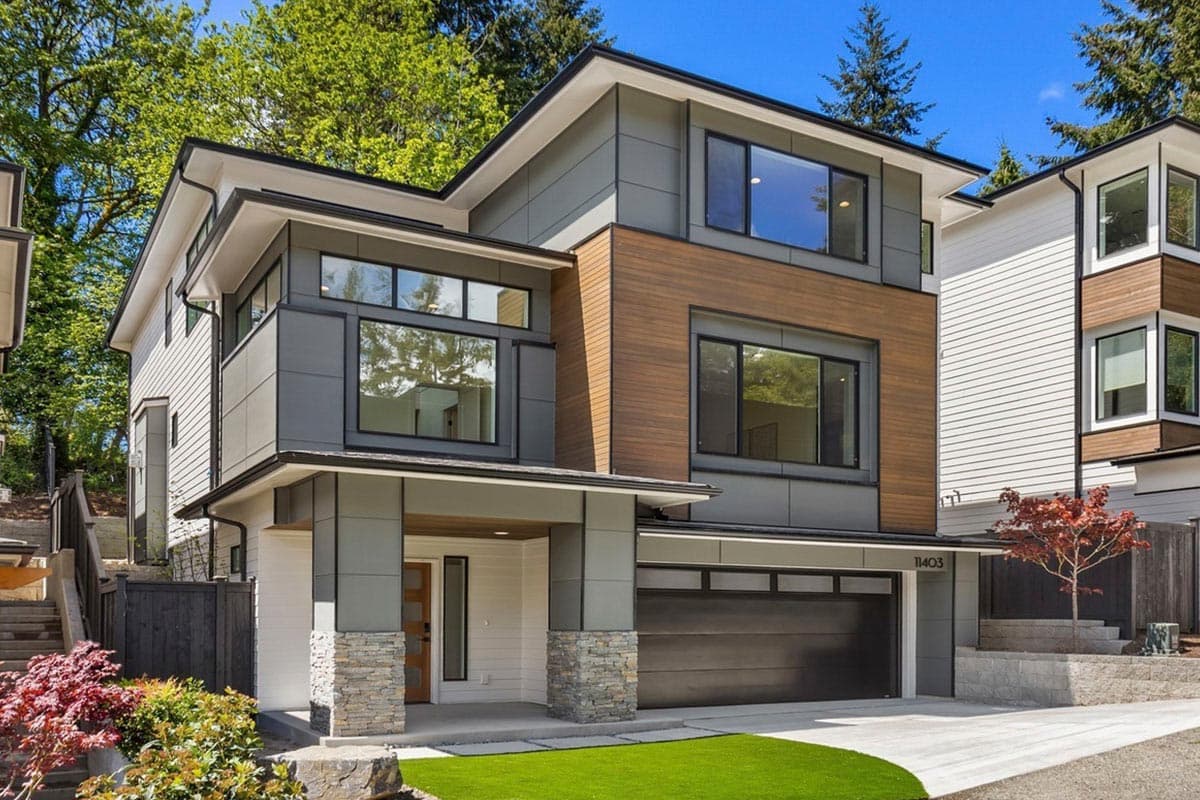 Modern house plan exterior with wood siding, large windows, cantilevers, and an attached garage.