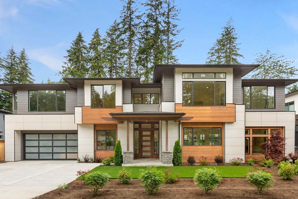 House plan exterior. Modern style, two-story home. Features include a flat roof, large windows, and a detached garage with glass door.