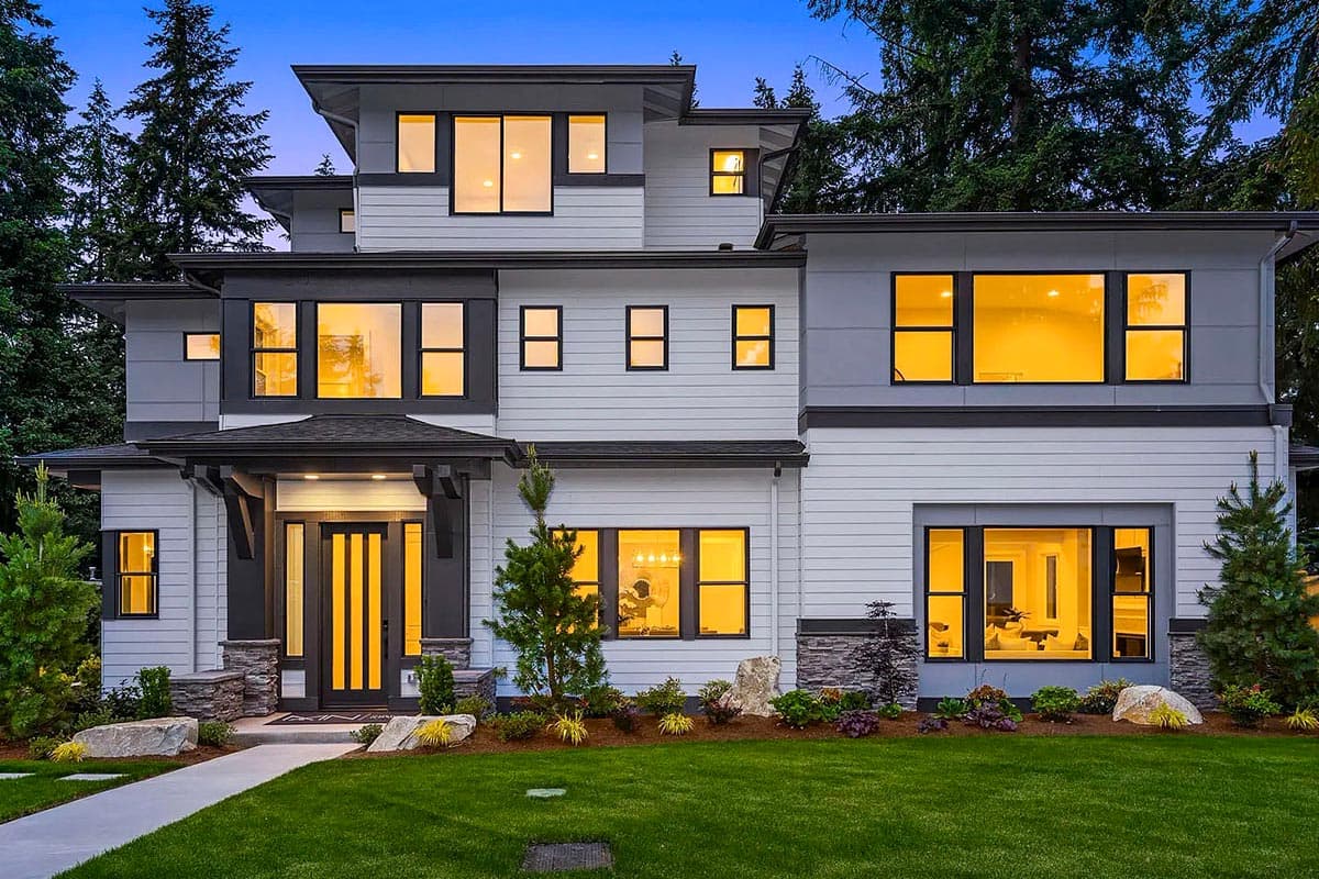 House plan exterior. Modern style, two-story home. Features include flat rooflines, multiple window arrangements, and a covered entry with columns.