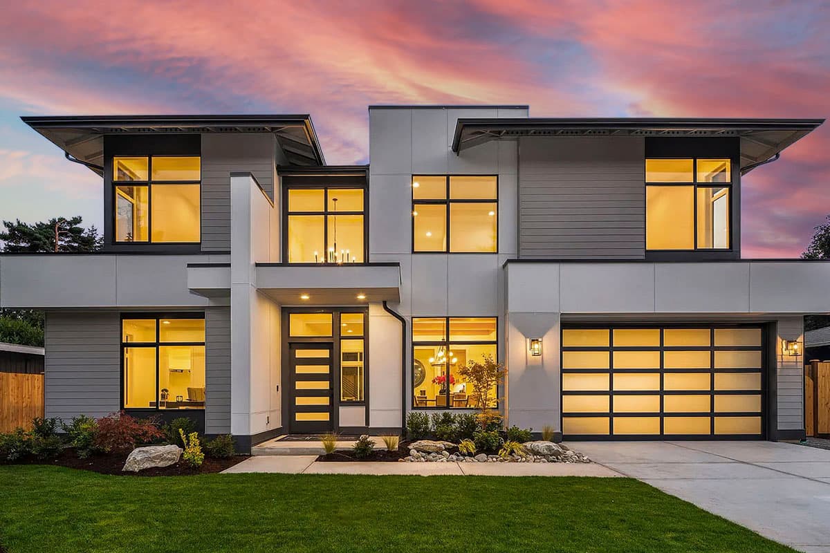 Modern house plan exterior with two stories. Features include a flat roof, large windows, an attached garage, and a covered entry.