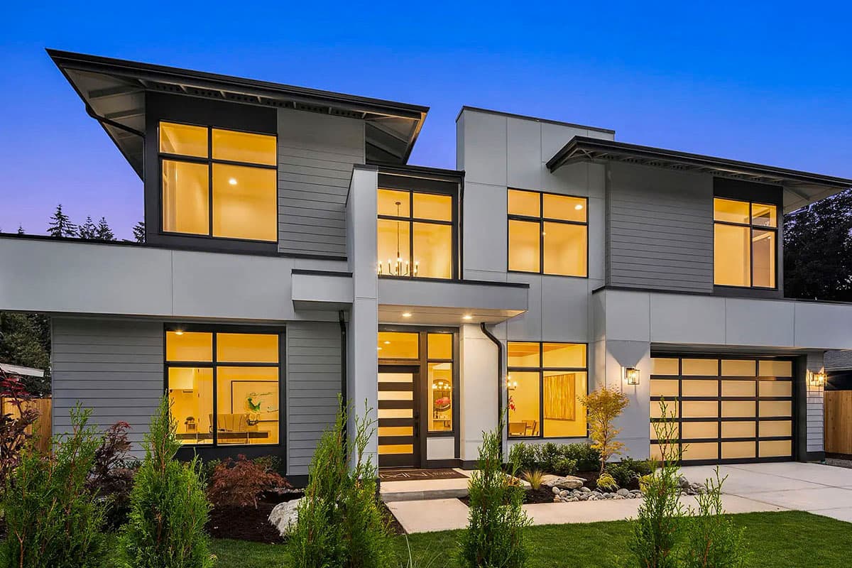 Modern two-story house plan exterior with a flat roof, multiple gables, and a glass panel garage door.