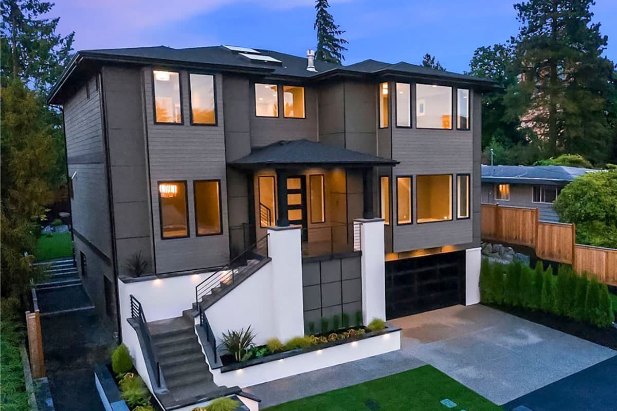 House plan exterior with two stories. Modern style with flat roof, covered entry, and large windows. Includes attached garage and landscaping.