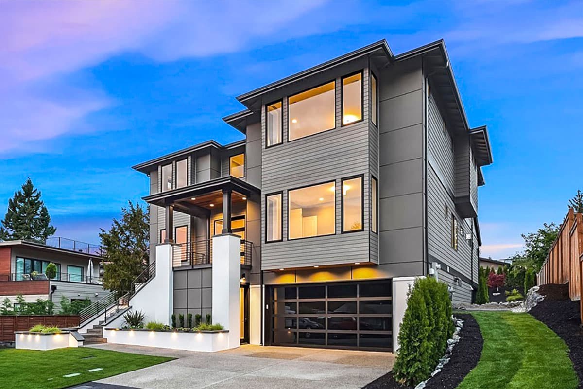 Modern house plan exterior with stacked levels, large windows, cantilevered porch, and glass garage door.